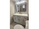 Modern bathroom with white vanity, black hardware, and a large mirror at 3002 W Cleveland St # E1, Tampa, FL 33609