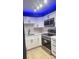 Modern kitchen with stainless steel appliances and white cabinetry at 3002 W Cleveland St # E1, Tampa, FL 33609
