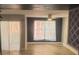 Living room with hardwood floors, ceiling fan, and large windows at 3002 W Cleveland St # E1, Tampa, FL 33609