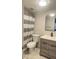 Updated bathroom with gray vanity, white toilet and striped shower curtain at 3002 W Cleveland St # E1, Tampa, FL 33609
