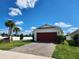 Single-story home with red garage door and landscaped yard at 11883 Brighton Knoll Loop, Riverview, FL 33579