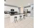 Bright kitchen with white cabinets, stainless steel appliances, and a sleek breakfast bar with seating for three at 11883 Brighton Knoll Loop, Riverview, FL 33579