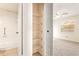 Bathroom and bedroom with a combination shower and tub, linen closet, and neutral carpeting at 2222 Greenhaven Dr, Sun City Center, FL 33573