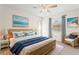Comfortable bedroom with a cozy seating area, ceiling fan, and a large bed at 2222 Greenhaven Dr, Sun City Center, FL 33573