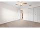 Bright bedroom with carpet, closet, ceiling fan and adjacent bathroom at 2222 Greenhaven Dr, Sun City Center, FL 33573