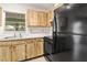 Well-lit kitchen boasts wood cabinets, and practical appliances at 2222 Greenhaven Dr, Sun City Center, FL 33573