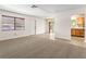 Inviting living room with tile and carpet flooring, leading to a bright dining area at 2222 Greenhaven Dr, Sun City Center, FL 33573