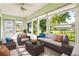 Bright sunroom with comfortable seating and large windows overlooking a well-maintained lawn at 2222 Greenhaven Dr, Sun City Center, FL 33573
