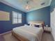 Cozy bedroom featuring a queen-size bed, a ceiling fan, and a window with shutters for privacy at 4977 Sapphire Sound Dr, Wimauma, FL 33598