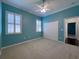 Well-lit bedroom featuring carpet, window shutters, and double doors at 4977 Sapphire Sound Dr, Wimauma, FL 33598