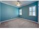 Bright bedroom with neutral walls, carpet, and window shutters at 4977 Sapphire Sound Dr, Wimauma, FL 33598