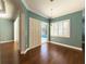 Dining room with hardwood floors and view of the pool through white shutters at 4977 Sapphire Sound Dr, Wimauma, FL 33598