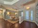 Dining room features hardwood floors, vaulted ceiling, and plenty of natural light, creating a welcoming space at 4977 Sapphire Sound Dr, Wimauma, FL 33598