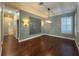 Spacious dining area featuring hardwood floors and an accent wall at 4977 Sapphire Sound Dr, Wimauma, FL 33598