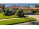 Two-story house with a three-car garage and well-manicured lawn at 4977 Sapphire Sound Dr, Wimauma, FL 33598