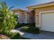 Side view of house with a walkway to the front door and lush landscaping at 4977 Sapphire Sound Dr, Wimauma, FL 33598