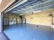 Organized garage with overhead storage, cabinets, and epoxy flooring at 4977 Sapphire Sound Dr, Wimauma, FL 33598