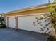 A three car garage with brick paver driveway offers plenty of parking space for vehicles and storage at 4977 Sapphire Sound Dr, Wimauma, FL 33598