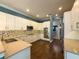 Spacious kitchen with white cabinets, stainless steel appliances, and granite countertops at 4977 Sapphire Sound Dr, Wimauma, FL 33598