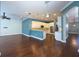 Modern kitchen with white cabinets, breakfast bar, and dark hardwood floors at 4977 Sapphire Sound Dr, Wimauma, FL 33598