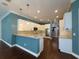 Modern kitchen with white cabinets, tile backsplash, and island at 4977 Sapphire Sound Dr, Wimauma, FL 33598