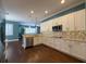 Modern kitchen featuring white cabinetry, stainless steel appliances, and hardwood floors at 4977 Sapphire Sound Dr, Wimauma, FL 33598