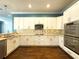 Bright kitchen boasts white cabinets, stainless steel appliances, and a tile backsplash at 4977 Sapphire Sound Dr, Wimauma, FL 33598
