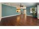 Open living room with hardwood floors and kitchen views at 4977 Sapphire Sound Dr, Wimauma, FL 33598