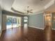 Bright living room with hardwood floors, pool view, and ceiling fan at 4977 Sapphire Sound Dr, Wimauma, FL 33598