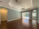 Spacious living room with hardwood floors, and sliding glass doors leading to the pool at 4977 Sapphire Sound Dr, Wimauma, FL 33598