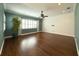 Living room with hardwood floors, patterned wall, and ceiling fan at 4977 Sapphire Sound Dr, Wimauma, FL 33598