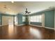 Living room with hardwood floors, plant, and access to a patio at 4977 Sapphire Sound Dr, Wimauma, FL 33598