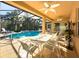 Outdoor patio with seating area, adjacent to the refreshing pool at 4977 Sapphire Sound Dr, Wimauma, FL 33598