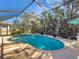 Relaxing screened pool with a waterfall feature and patio furniture at 4977 Sapphire Sound Dr, Wimauma, FL 33598