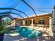 Inviting pool area with screened enclosure and patio furniture at 4977 Sapphire Sound Dr, Wimauma, FL 33598