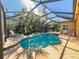 Screened pool and patio area with lush tropical landscaping at 4977 Sapphire Sound Dr, Wimauma, FL 33598