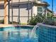 Stunning pool with a water feature and blue tile accents at 4977 Sapphire Sound Dr, Wimauma, FL 33598