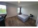 Bright bedroom with large bed, carpeted floor, and window views at 11883 Brighton Knoll Loop, Riverview, FL 33579