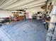 Spacious two-car garage with ample storage shelving and workbench at 11883 Brighton Knoll Loop, Riverview, FL 33579