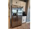 Stainless steel refrigerator in kitchen with white cabinets at 11883 Brighton Knoll Loop, Riverview, FL 33579