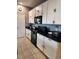 Kitchen with white cabinets, black countertops, and appliances at 11883 Brighton Knoll Loop, Riverview, FL 33579