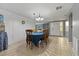 Dining area with tiled floor and a wooden table, offering a view of the entryway at 2119 Sugarbush Dr, Holiday, FL 34690