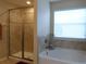 Bathroom featuring a shower and soaking tub at 2387 Bartolo Dr, Land O Lakes, FL 34639