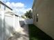 Side yard with paved walkway and privacy fence at 2387 Bartolo Dr, Land O Lakes, FL 34639