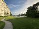 Peaceful waterfront path with a bench overlooking the water at 4650 Cove Cir # 604, St Petersburg, FL 33708