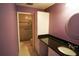 Bathroom with dark granite countertop and glass-door shower at 1601 43Rd S N St # 224, St Petersburg, FL 33713