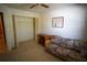 Bedroom with ceiling fan, closet, and a floral sofa at 1601 43Rd S N St # 224, St Petersburg, FL 33713