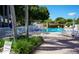 Inviting community pool area with lounge chairs and tables for relaxation on a sunny day at 1601 43Rd S N St # 224, St Petersburg, FL 33713