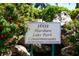 Attractive signage for 1601 Harshaw Lake Park Condominiums amid lush, colorful landscaping at 1601 43Rd S N St # 224, St Petersburg, FL 33713