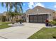 Charming one-story home with a two-car garage and well-manicured lawn at 825 Regal Manor Way, Sun City Center, FL 33573